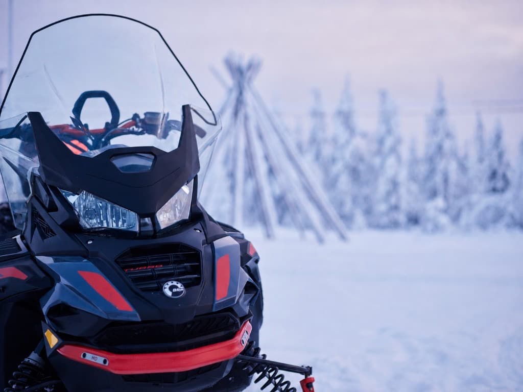 Snowmobile crossing a frozen lake